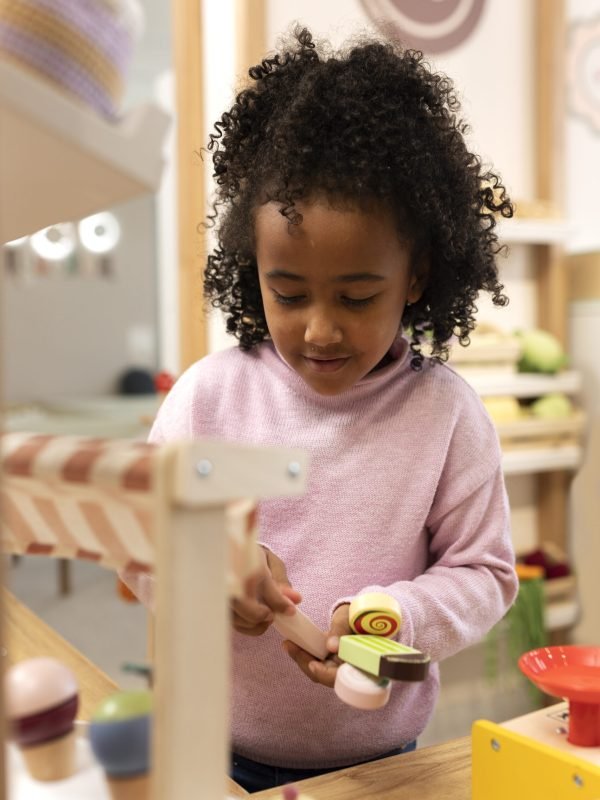 front-view-girl-playing-with-ecological-toys